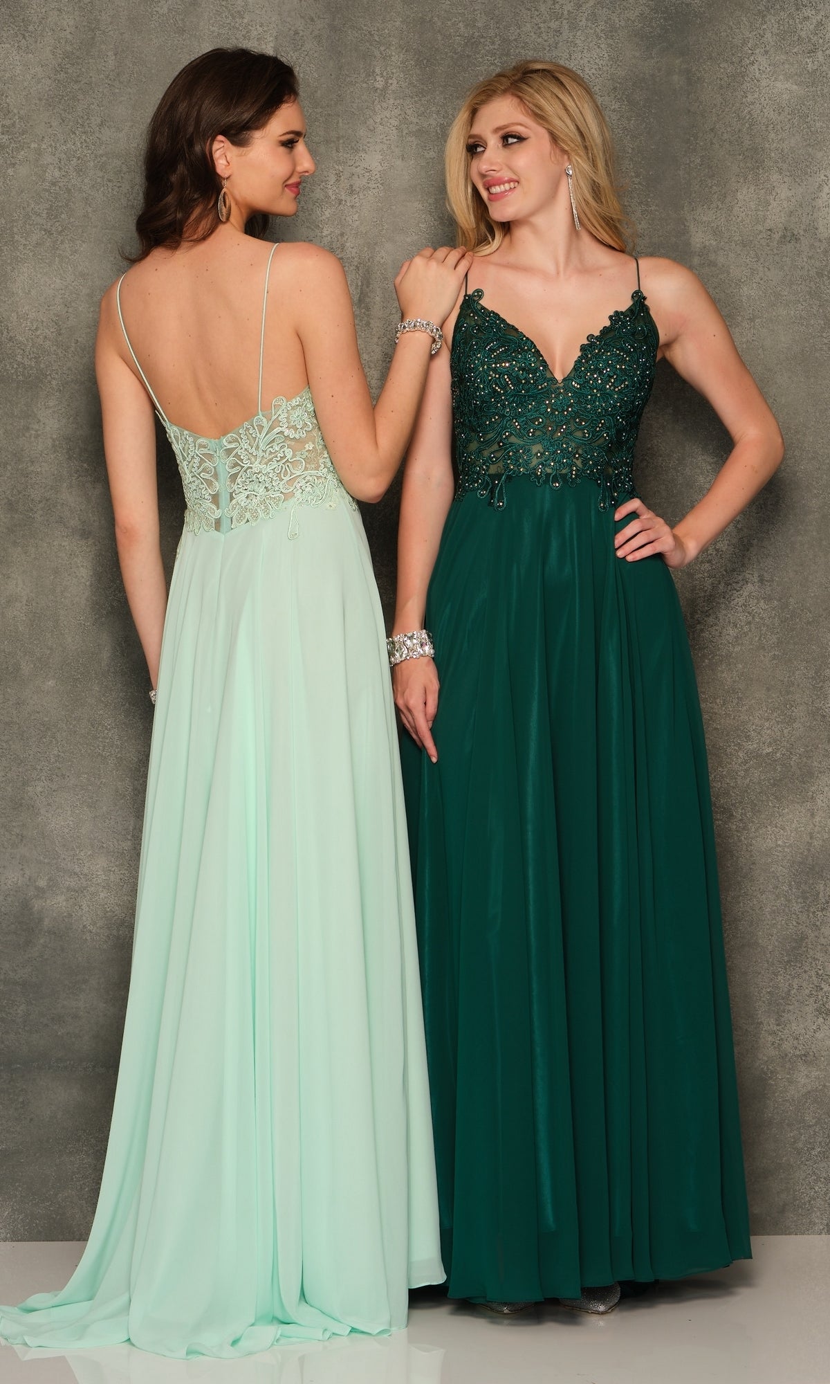 Two women stand side by side, smiling in elegant Dave and Johnny gowns. One wears the Classic Long A-Line Prom Gown (Dave & Johnny A7248) in light mint green with an embroidered-lace bodice; the other wears dark green with a beaded bodice.